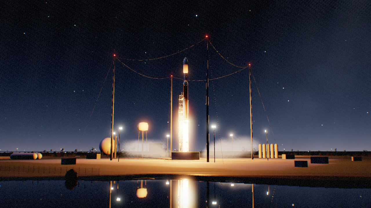 An Atlas V lifting off at night, its flame mirrored in a pond in the foreground, with storage tanks, a fence and lightning masts around the pad.