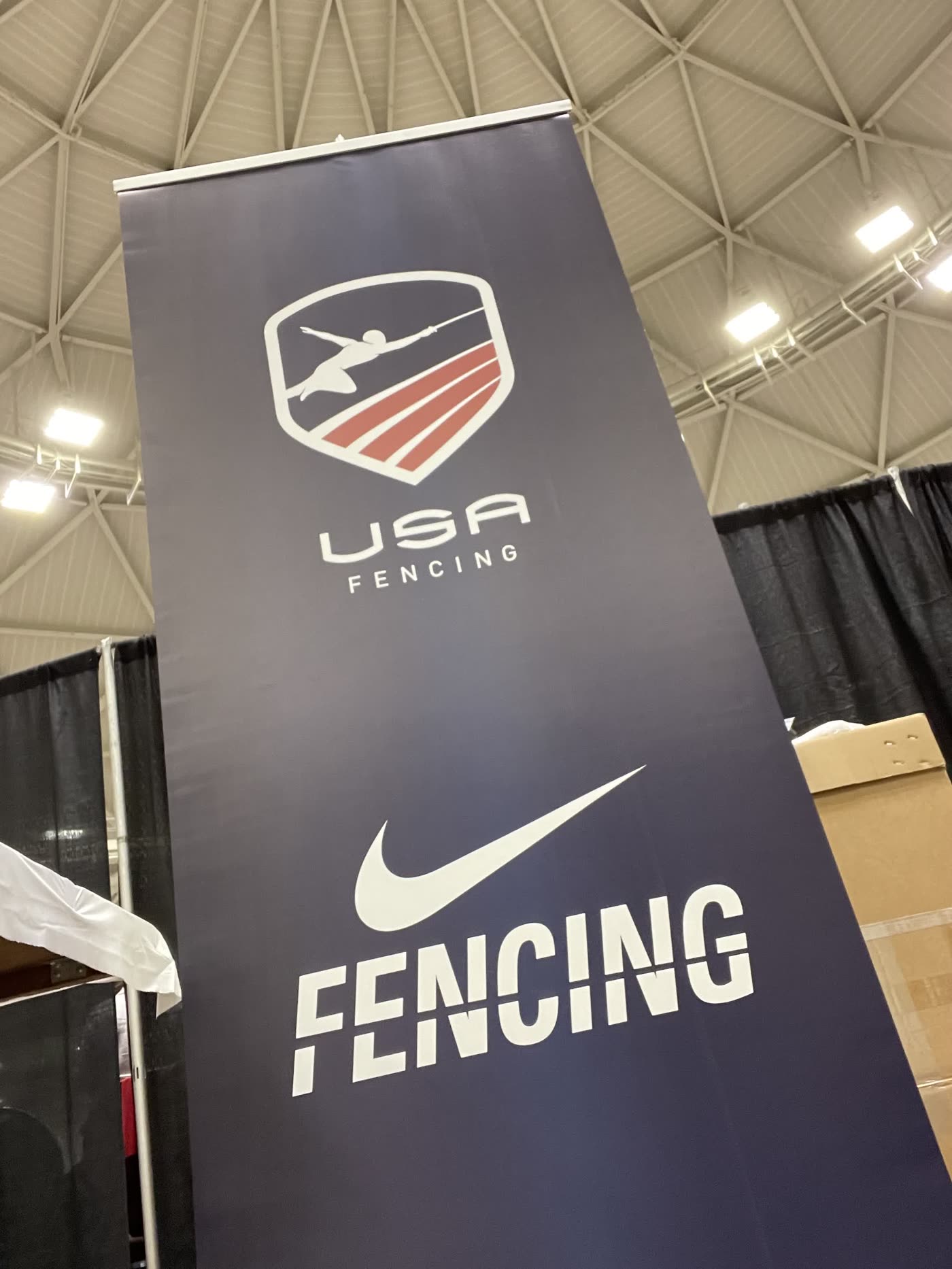 USA Fencing and Nike Fencing banner hanging in a competition venue