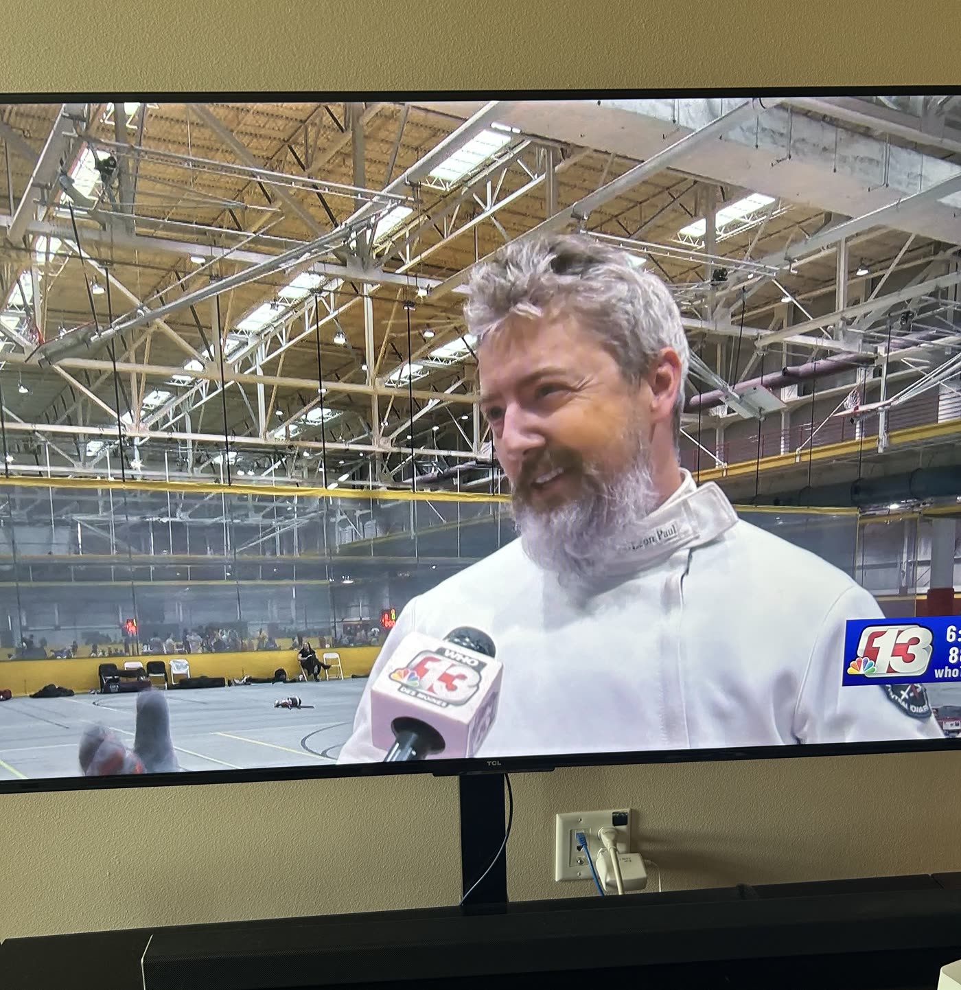 Television showing the WHO13 broadcast of Eric Rhea's Iowa Games interview