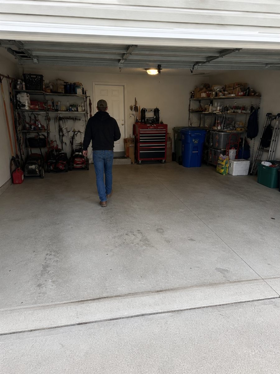 Generated image of John standing in a suburban garage at the beginning of the world exploration.